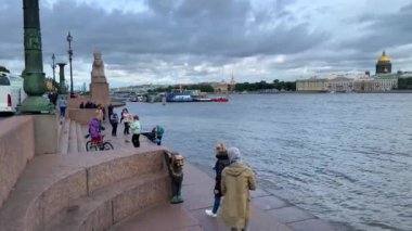 Saint-Petersburg - Russia October 4, 2022: Griffon and Sphinx statues by the Neva River. Municipal Okrug 7. Neva River overview with tourist boats and ships. University Embarkment.