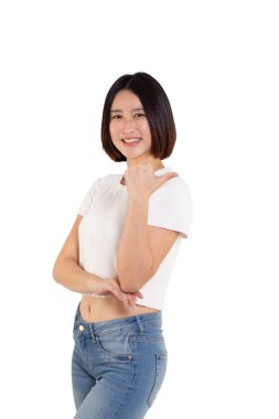 portrait of a Happy Asian woman smiling points her index finger at an empty space in the background and looks straight ahead on white background