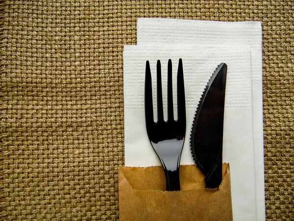 Plastic Black Fork Knife White Napkin Background Rough Fabric — Stock Photo, Image