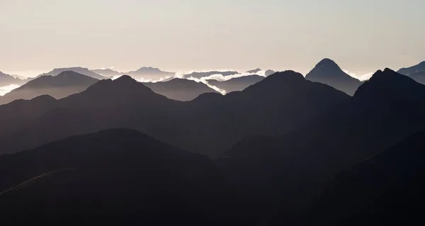 Alpine mountain silhouette layers, nature landscape panorama seen from Mount Armstrong Brewster Hut West Coast Otago Southern Alps South Island New Zealand