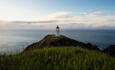 Okyanus kıyısındaki kayalık Cape Reinga Aupouri Yarımadası Northland Kuzey Adası Yeni Zelanda 'da bulunan tarihi beyaz deniz fenerinin panoramik manzarası