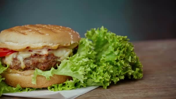 Close Big Burger Trova Carta Bianca Artigianale Contro Tavolo Legno — Video Stock
