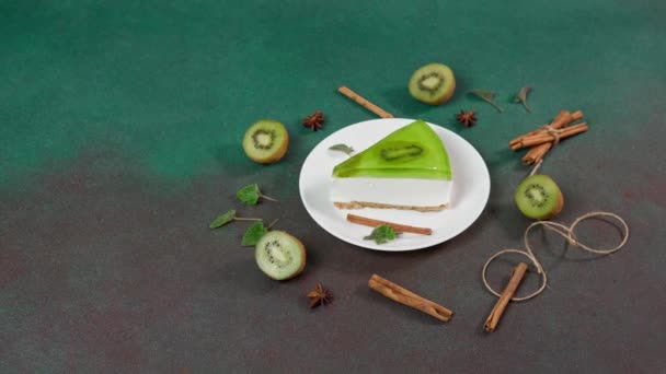 キウイ シナモンスティックとチーズケーキと緑の背景にミントを残します テキストのCpaseをコピー — ストック動画