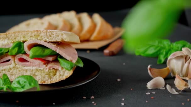 Ciabatta Sandwich Ham Pesto Sauce Tomatoes Basil Black Background Їжа — стокове відео
