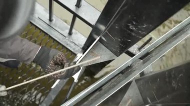 Kaynakçı metal bir boru kaynak yapar. Demir kaynaklama