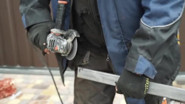 アングルグラインダーを使用して金属チューブを切断する労働者 明るい火花とフラッシュ — ストック動画