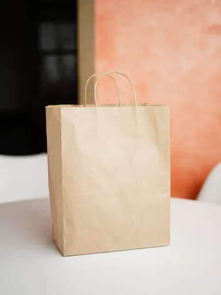 Paper bags on white table. Craft paper bag mock-up on the white table. Copy space for text