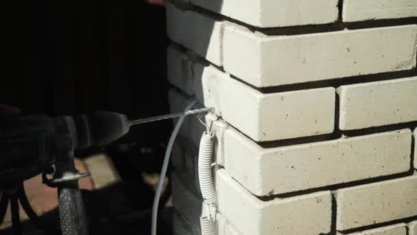 건축업자 교련을 구멍을 교련하십시오 구멍을 만드는 천공기의 클로즈업 — 비디오
