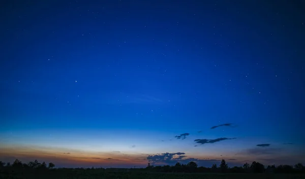 Landscape of the sunset sky. Evening summer sky with stars and bright horizon.