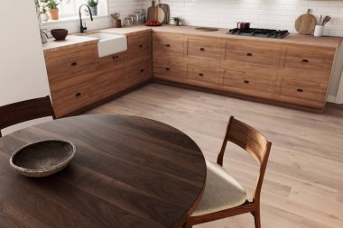 Bu şık, modern mutfak güzel ahşap dolaplar ve büyüleyici yuvarlak bir yemek masası sergiliyor.