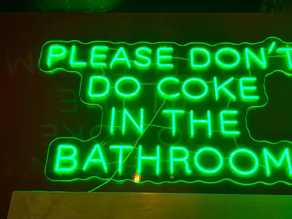 Umumi tuvaletin üstündeki neon-kola tabelası..