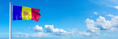 Andorra Flag - state of Europe, flag waving on a blue sky in beautiful clouds - Horizontal banner