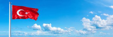 Turkey Flag - state of Europe, flag waving on a blue sky in beautiful clouds - Horizontal banner