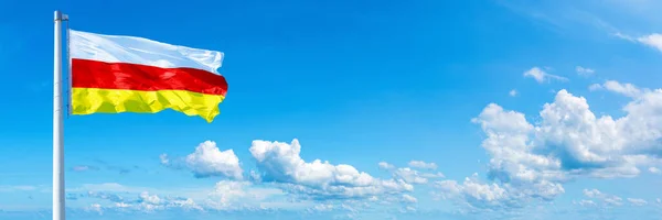 South Ossetia Flag Waving Blue Sky Beautiful Clouds Horizontal Banner — Stock Photo, Image