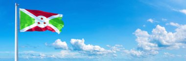 Burundi Flag - state of Africa, flag waving on a blue sky in beautiful clouds - Horizontal banner