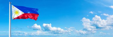 Philippines Flag - state of USA, flag waving on a blue sky in beautiful clouds - Horizontal banner
