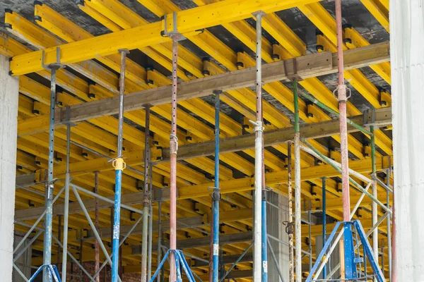 Metal supports hold the structure of the future reinforced concrete floor.