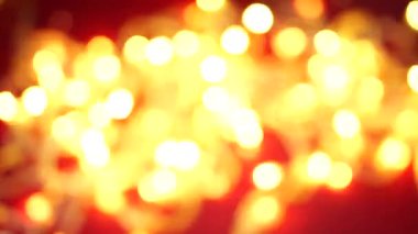 Red blurred background with yellow blurred lights. Light bokeh overlay. Multicolored light bokeh footage