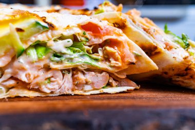 Salata ve domates gibi taze sebzeli sulu pita ekmeği, sıcak tortilla arasına katılmış, hızlı bir yemek veya atıştırmalık için mükemmel..