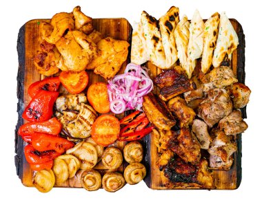 Ahşap tahtalarda çeşitli ızgara etler ve sebzeler ustalıkla düzenlenir. Yayılımda tavuk, kuzu, biber, soğan, canlı renkler ve dokular sergileniyor..