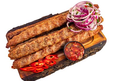 Sulu kebaplar mükemmel ızgara yapılır ve ahşap bir tabakta sunulur. Kırmızı soğan dilimleri ve taze kırmızı biber ile birlikte küçük bir kase canlı salsa sosuna eşlik eder..