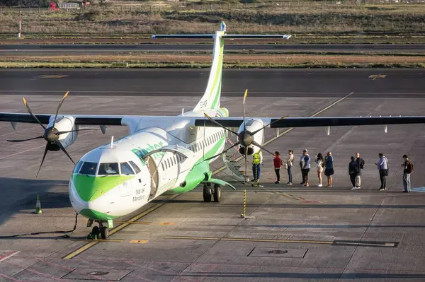 stock image Tenerife, Spain; 04-23-2024: Passengers accessing the Binter company propeller plane and the ATR 72-600 model before takeoff at the Tenerife North airport