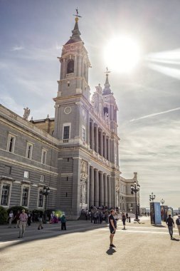 Madrid, Spain; 05-10-2024: Almudena Cathedral in Madrid, neoclassical style on a spring day with crowds of tourists in front of its main facade clipart
