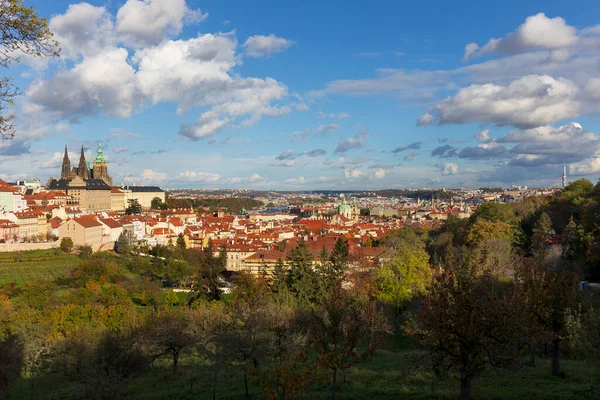 stock image Autumn Prague City with gothic Castle, colorful Nature and Trees and dramatic Sky from the Hill Petrin, Czech Republic