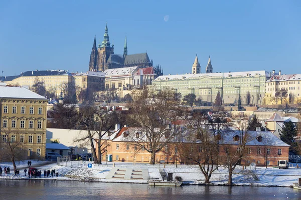 stock image Snowy Prague Lesser Town with Prague Castle above River Vltava in the sunny Day , Czech republic