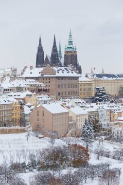 Snowy Prague City with gothic Castle from the Hill Petrin, Czech republic  clipart