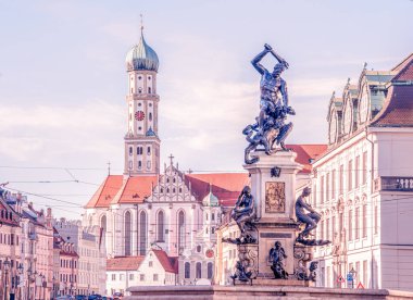 View of the fountain and Basilika St. Ulrich und Afra in the city center of Augsburg.