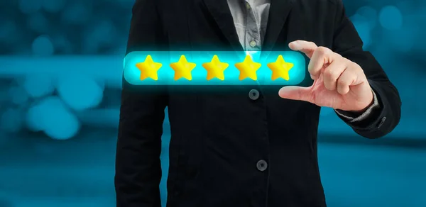 stock image a businessman choose on the five star to give satisfaction in service.rating very impressed.Customer service and Satisfaction concept.