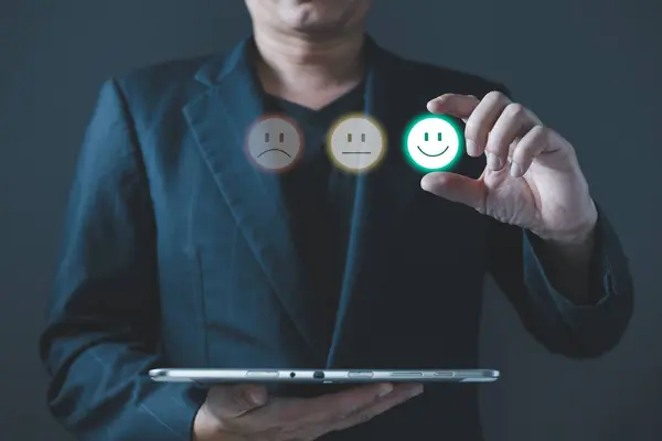 a businessman choose the virtual screen on the happy smile face icon to give satisfaction in service.rating very impressed.customer review service and Satisfaction concept