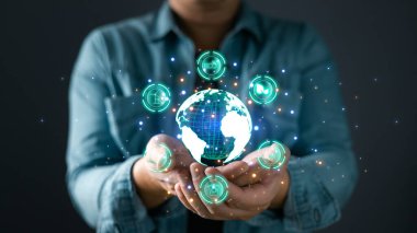 İnsanlar enerji tasarrufu yapmak ve küresel ısınmayı azaltmak için gezegeni büyütüyor, çevre bilinci fikri, karbon kredisi, sera gazı emisyonlarının azaltılması, Çevre Sosyal ve Yönetim ESG