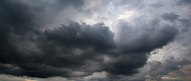 A turbulent sky filled with dark, dense clouds captures the intensity of an approaching windstorm, showcasing the raw power and unpredictability of severe weather conditions.