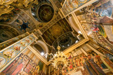Gorgeously decorated golden altar and frescoes on the walls in the interior of the Holy Dormition Cathedral in Pechersk Lavra in Kyiv, Ukraine January 7, 2023. High quality photo