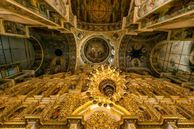 Gorgeously decorated golden altar and frescoes on the walls in the interior of the Holy Dormition Cathedral in Pechersk Lavra in Kyiv, Ukraine January 7, 2023. High quality photo