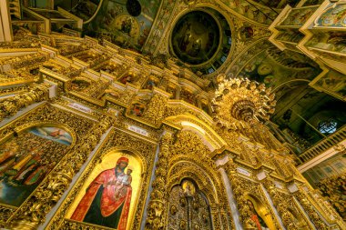 Gorgeously decorated golden altar and frescoes on the walls in the interior of the Holy Dormition Cathedral in Pechersk Lavra in Kyiv, Ukraine January 7, 2023. High quality photo