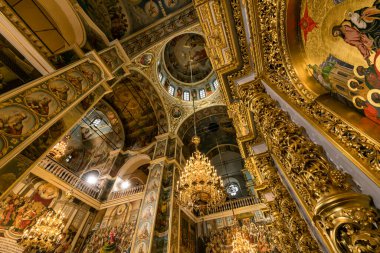 Gorgeously decorated golden altar and frescoes on the walls in the interior of the Holy Dormition Cathedral in Pechersk Lavra in Kyiv, Ukraine January 7, 2023. High quality photo