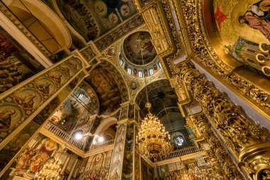 Gorgeously decorated golden altar and frescoes on the walls in the interior of the Holy Dormition Cathedral in Pechersk Lavra in Kyiv, Ukraine January 7, 2023. High quality photo