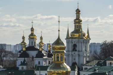 Panoramic view of Kyiv Pechersk Lavra churches, the Dnieper river and high buildings in Kyiv, Ukraine. February 2023. High quality photo