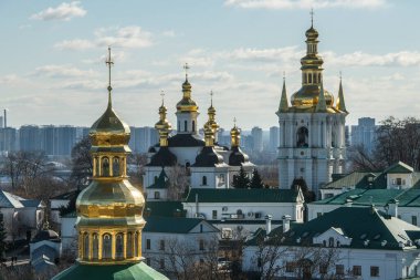 Panoramic view of Kyiv Pechersk Lavra churches, the Dnieper river and high buildings in Kyiv, Ukraine. February 2023. High quality photo