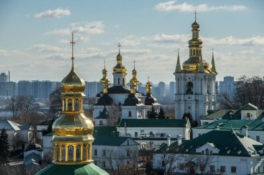 Panoramic view of Kyiv Pechersk Lavra churches, the Dnieper river and high buildings in Kyiv, Ukraine. February 2023. High quality photo