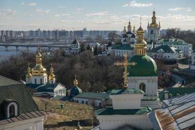 Panoramic view of Kyiv Pechersk Lavra churches, the Dnieper river and high buildings in Kyiv, Ukraine. February 2023. High quality photo