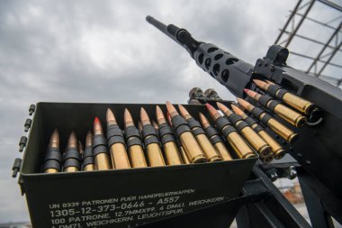 Member of the mobile air defence group checks a M2 Browning machine gun atop of a pick up truck in the Hostomel town, Ukraine, April 1, 2023. High quality photo clipart