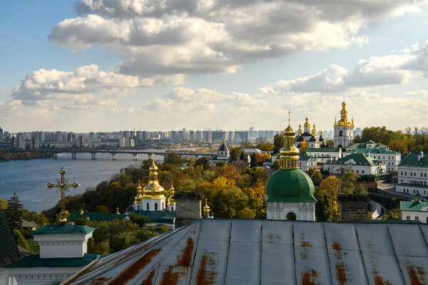 Panoramic view of Kyiv Pechersk Lavra churches, the Dnieper river and high buildings in Kyiv, Ukraine. October 23, 2023. High quality photo