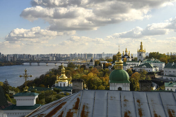 Panoramic view of Kyiv Pechersk Lavra churches, the Dnieper river and high buildings in Kyiv, Ukraine. October 23, 2023. High quality photo
