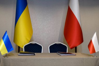 Ukrayna ve Polonya 'nın ulusal bayrakları ikili bir anlaşma, belge ve sözleşme imzaladıkları için masada. Yüksek kalite fotoğraf