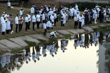 Orthodox Jewish pilgrims pray on the bank of lake near the tomb of Rabbi Nachman while celebrating Rosh Hashanah, Jewish New Year, amid Russia continues the war in Ukraine. Uman, Ukraine 16-09-2023 clipart