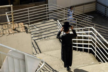 Ultra-Orthodox Jewish Hasids pilgrim prays on the street close to tomb of Rabbi Nachman on the eve of Rosh Hashanah holiday, Jewish New Year, in Uman, Ukraine 16-09-2023. High quality photo clipart